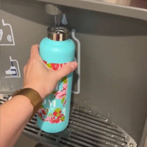 Bring a reusable water bottle and fill it up after you pass through Security